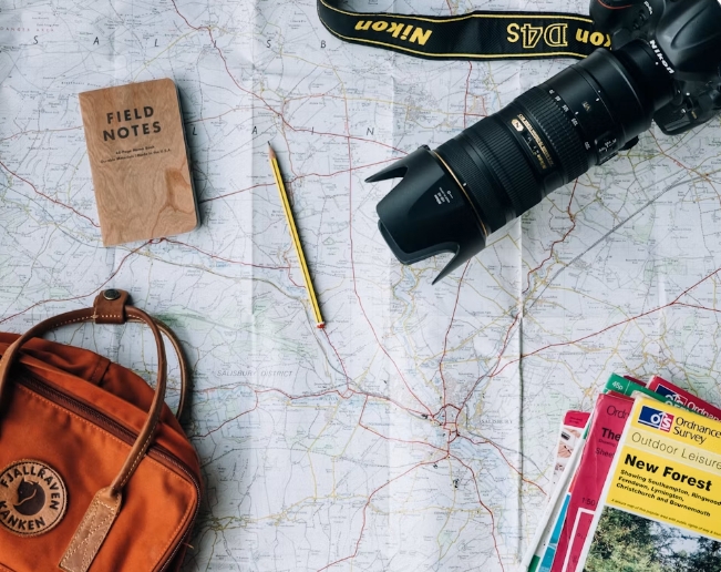 Travel planning with a map, notebook and camera